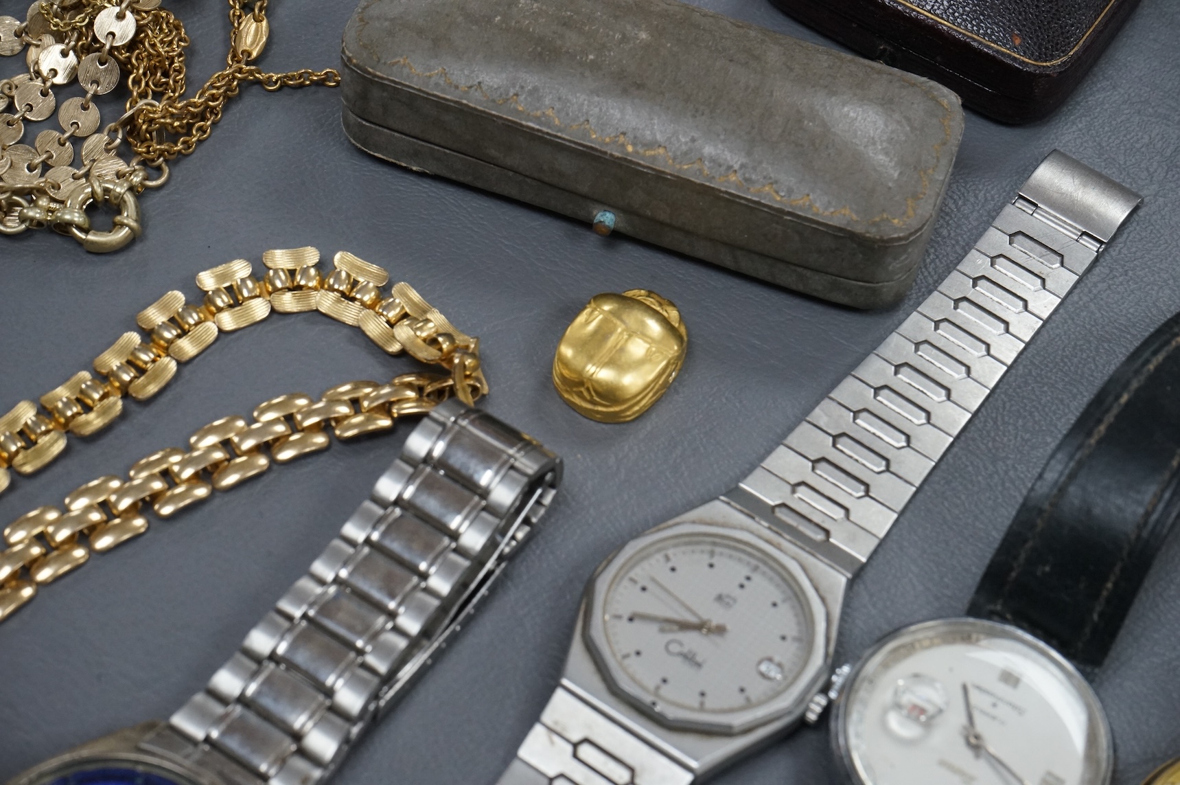 A quantity of assorted costume jewellery and other items including wrist watches, watch movements and a silver vesta case.